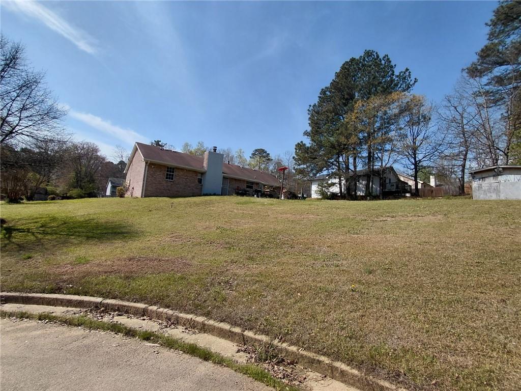 1608 Enchanted Forest Drive Conley, GA 30288 - Photo 6 of 22 a view of a field with trees in front of it