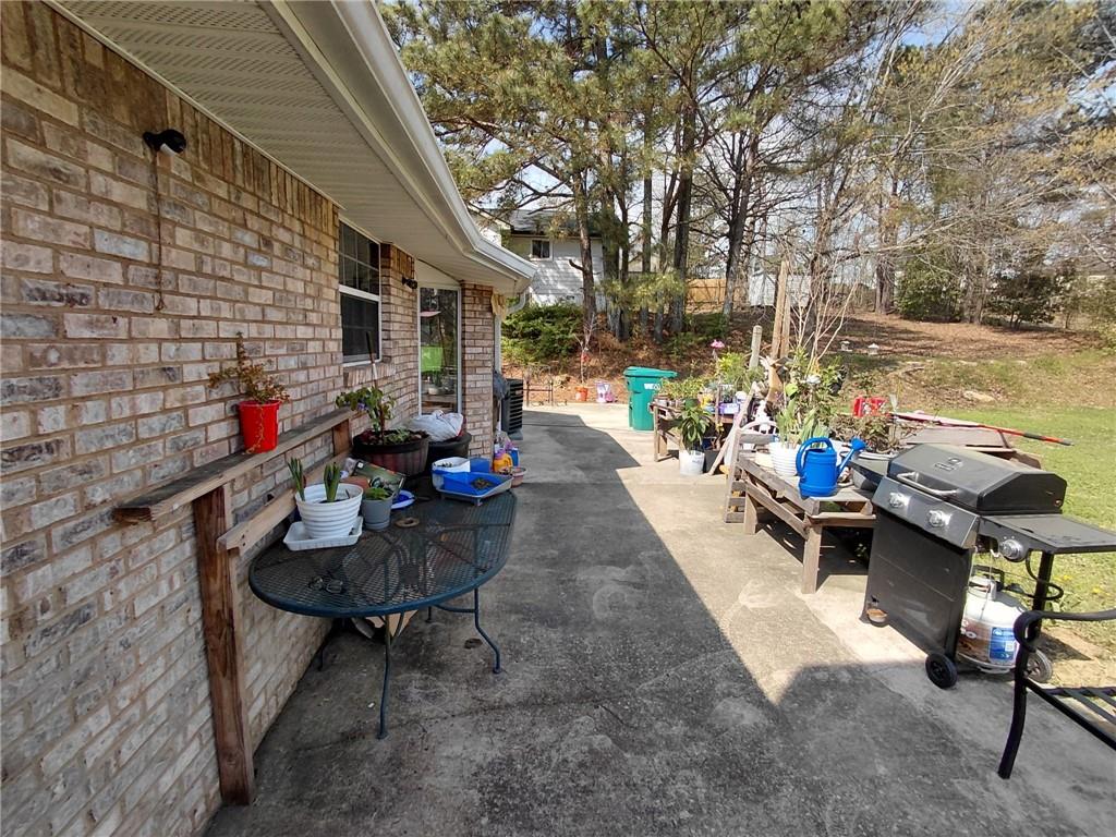 1608 Enchanted Forest Drive Conley, GA 30288 - Photo 7 of 22 a backyard of a house with table and chairs