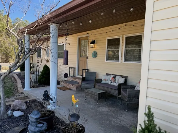 a backyard of a house with outdoor seating