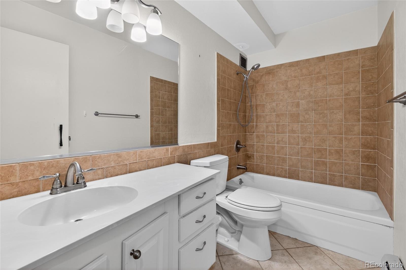 720 South Clinton Street, Unit B1 Denver, CO 80247 - Photo 13 of 19 a bathroom with a sink a toilet and shower