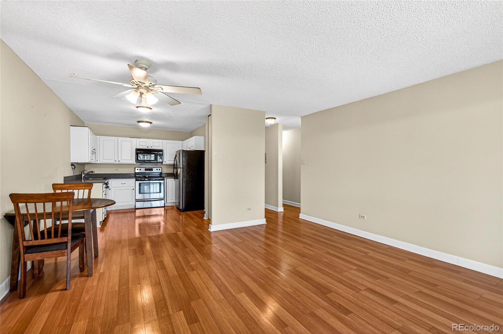 720 South Clinton Street, Unit B1 Denver, CO 80247 - Photo 5 of 19 a view of a kitchen with wooden floor and a kitchen