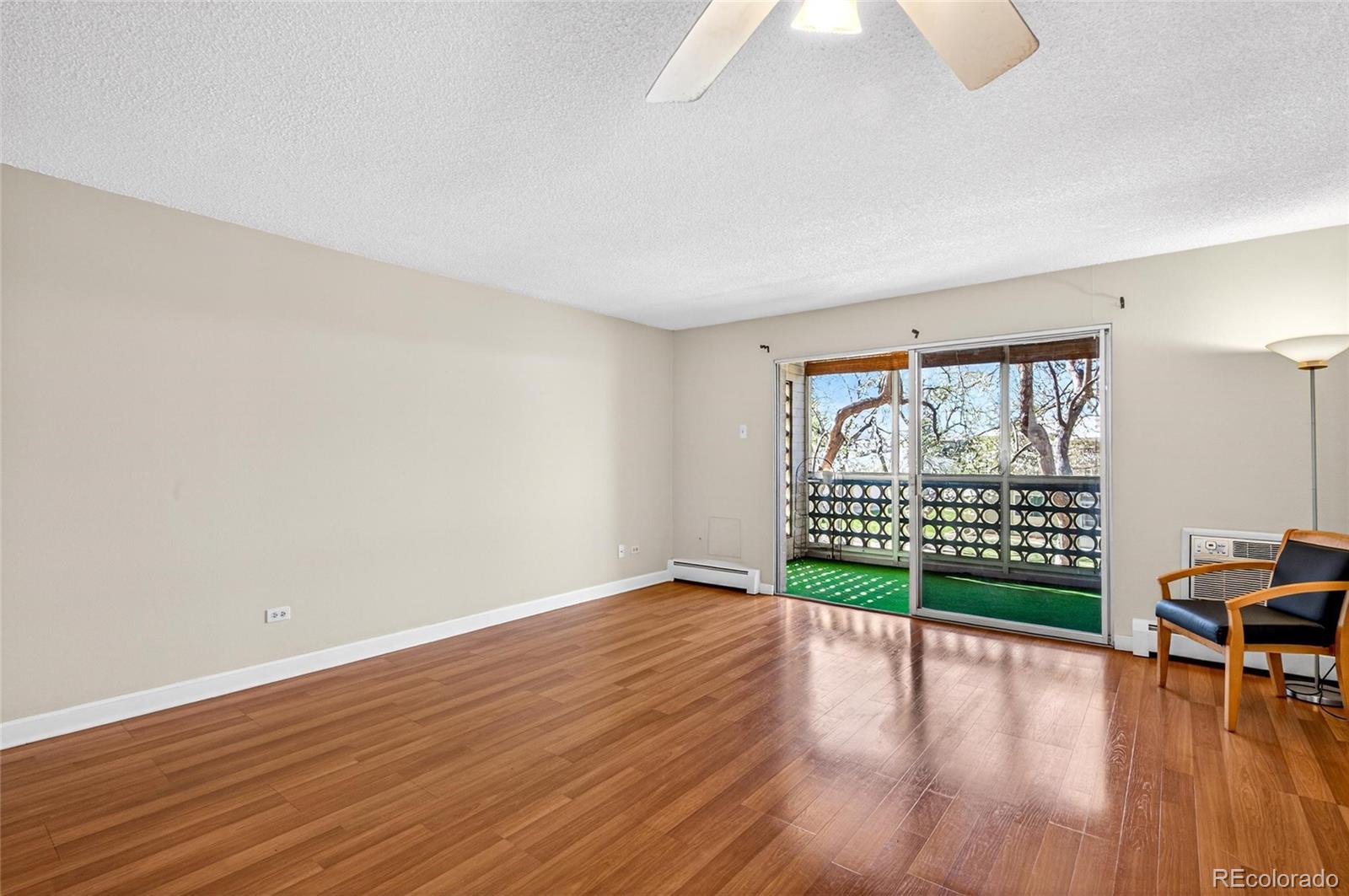 720 South Clinton Street, Unit B1 Denver, CO 80247 - Photo 8 of 19 a view of a room with wooden floor and windows