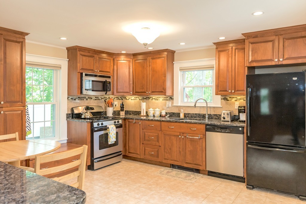 42 River Ridge Wellesley, MA 02481 - Photo 9 of 24 a kitchen with stainless steel appliances granite countertop a refrigerator a stove a sink and a microwave