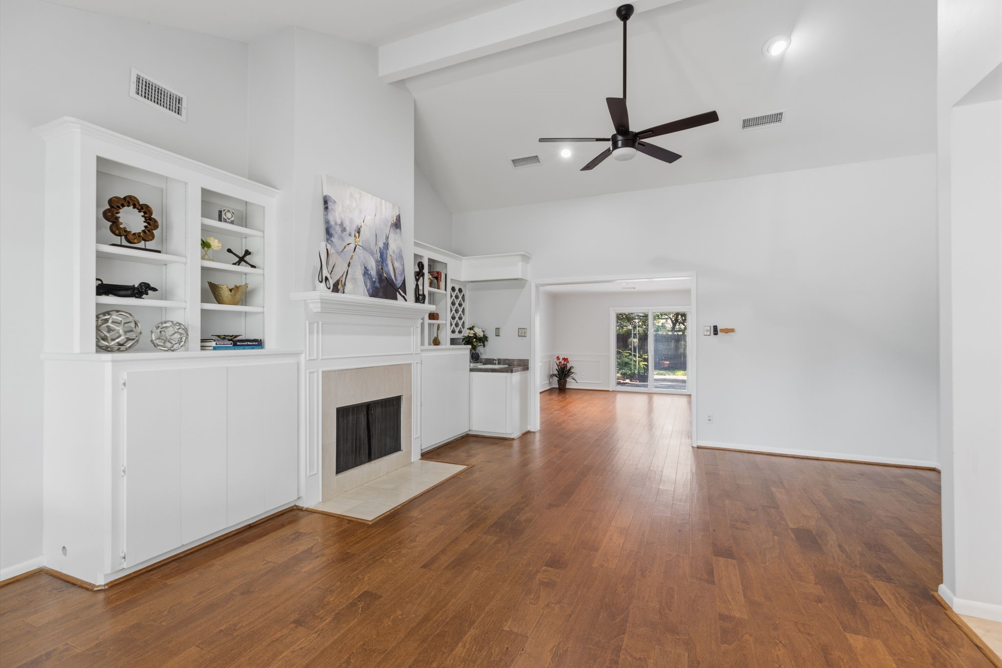 5410 Indigo Street Houston, TX 77096 - Photo 6 of 30 A great view of the gleaming floors, stately fireplace and built ins in living and dining areas and classic open flow throughout.