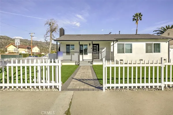 a view of a house with a small yard and plants