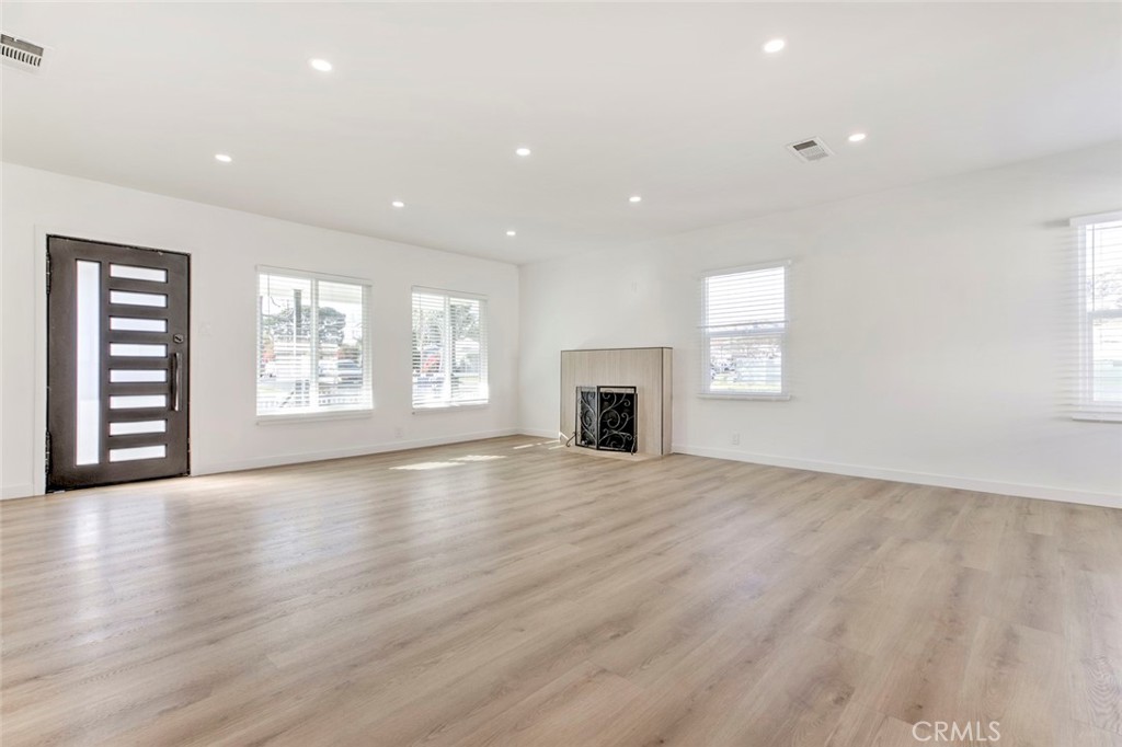 2238 North N Keystone Burbank, CA 91504 - Photo 5 of 21 an empty room with wooden floor fireplace and windows
