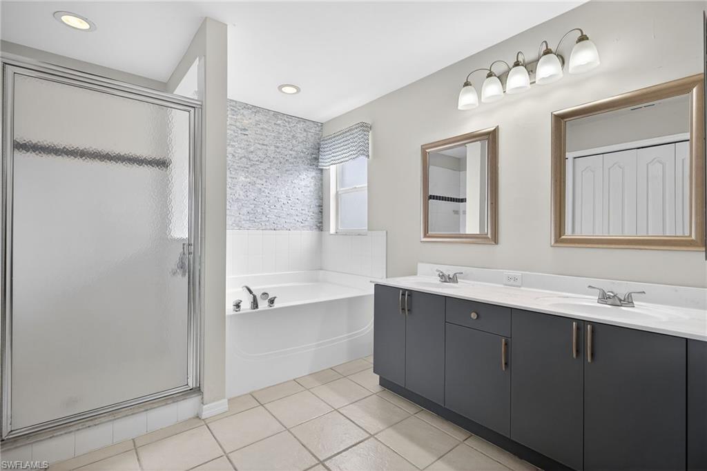 21560 Brixham Run Loop Estero, FL 33928 - Photo 20 of 43 Ensuite primary bathroom features a separate toilet room, walk-in shower, dual sinks and a LARGE walk in closet!
