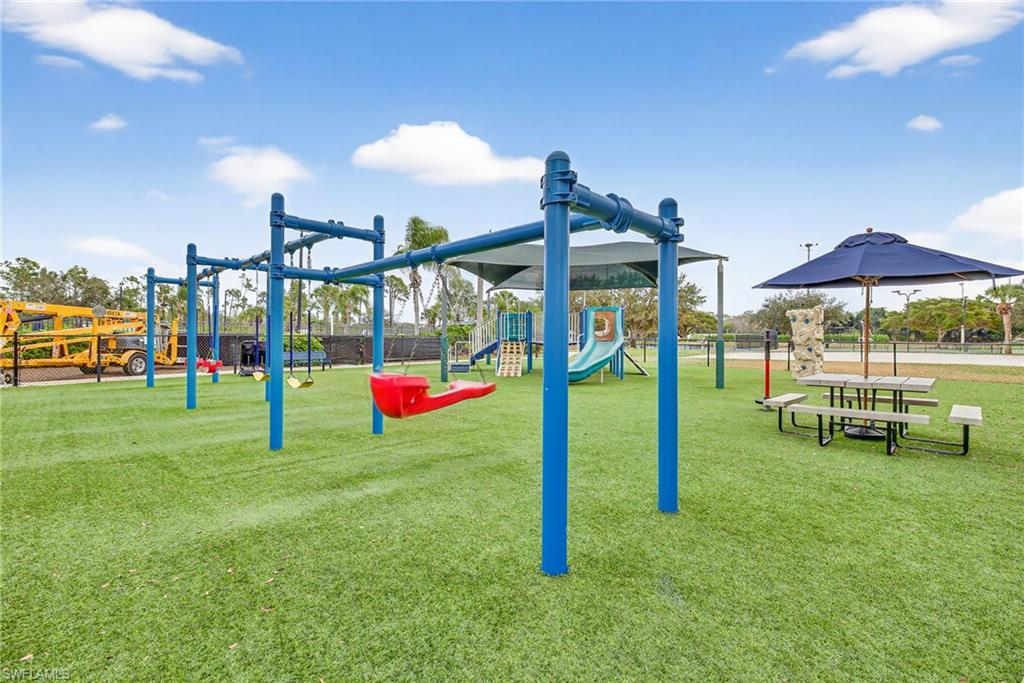 21560 Brixham Run Loop Estero, FL 33928 - Photo 40 of 43 Community playground offering a fun and safe space for outdoor play.