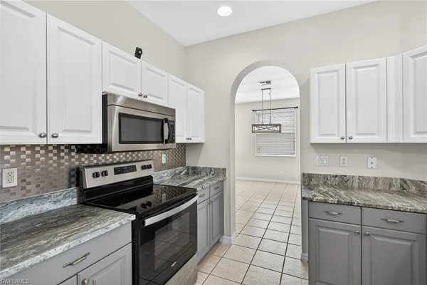 a kitchen with a sink stove and cabinets
