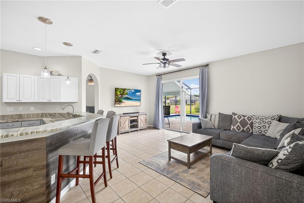 21560 Brixham Run Loop Estero, FL 33928 - Photo 10 of 43 Living room and kitchen are open to each other.