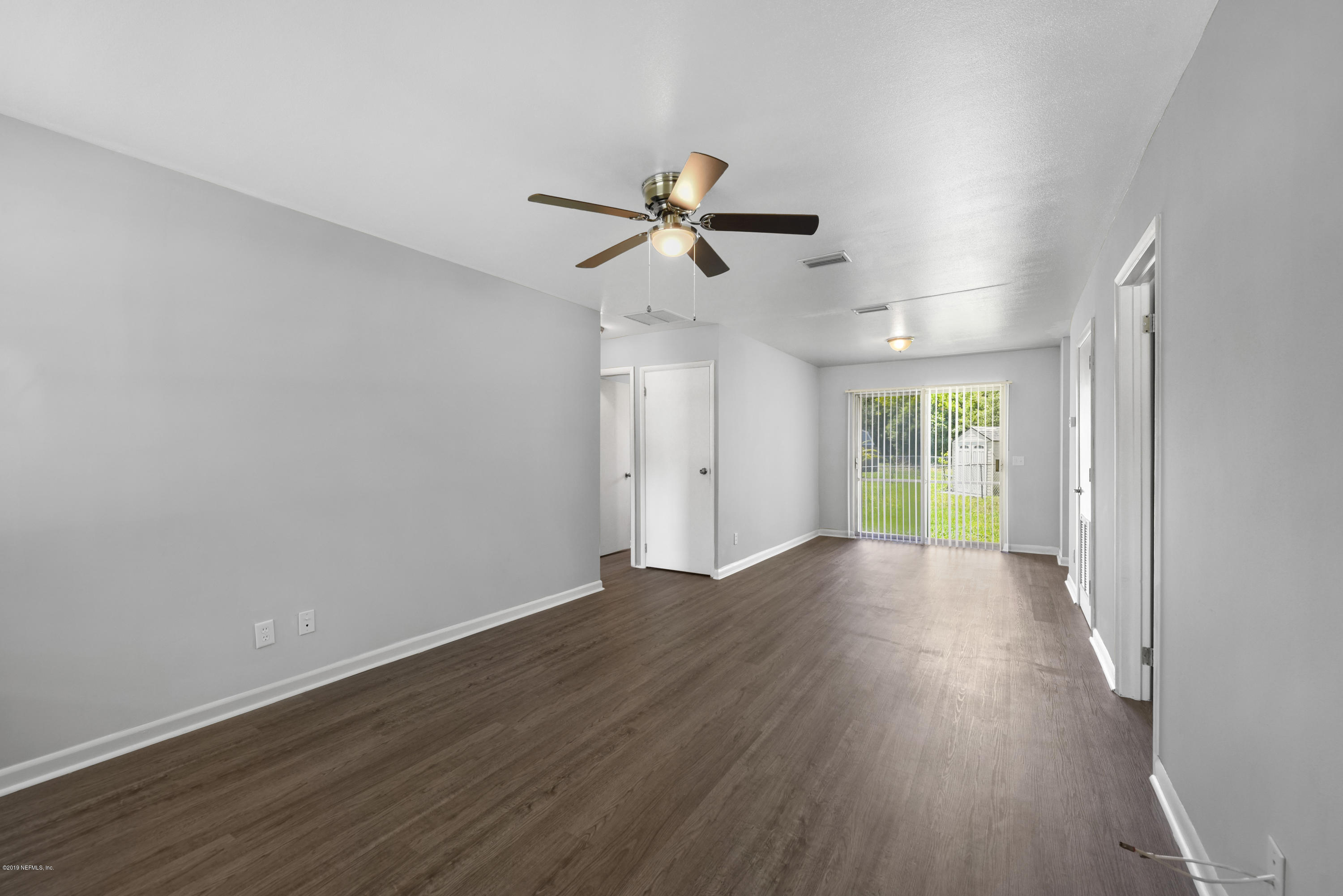 7384 Ridgeway Road North Jacksonville, FL 32244 - Photo 3 of 29 wooden floor in an empty room with a window