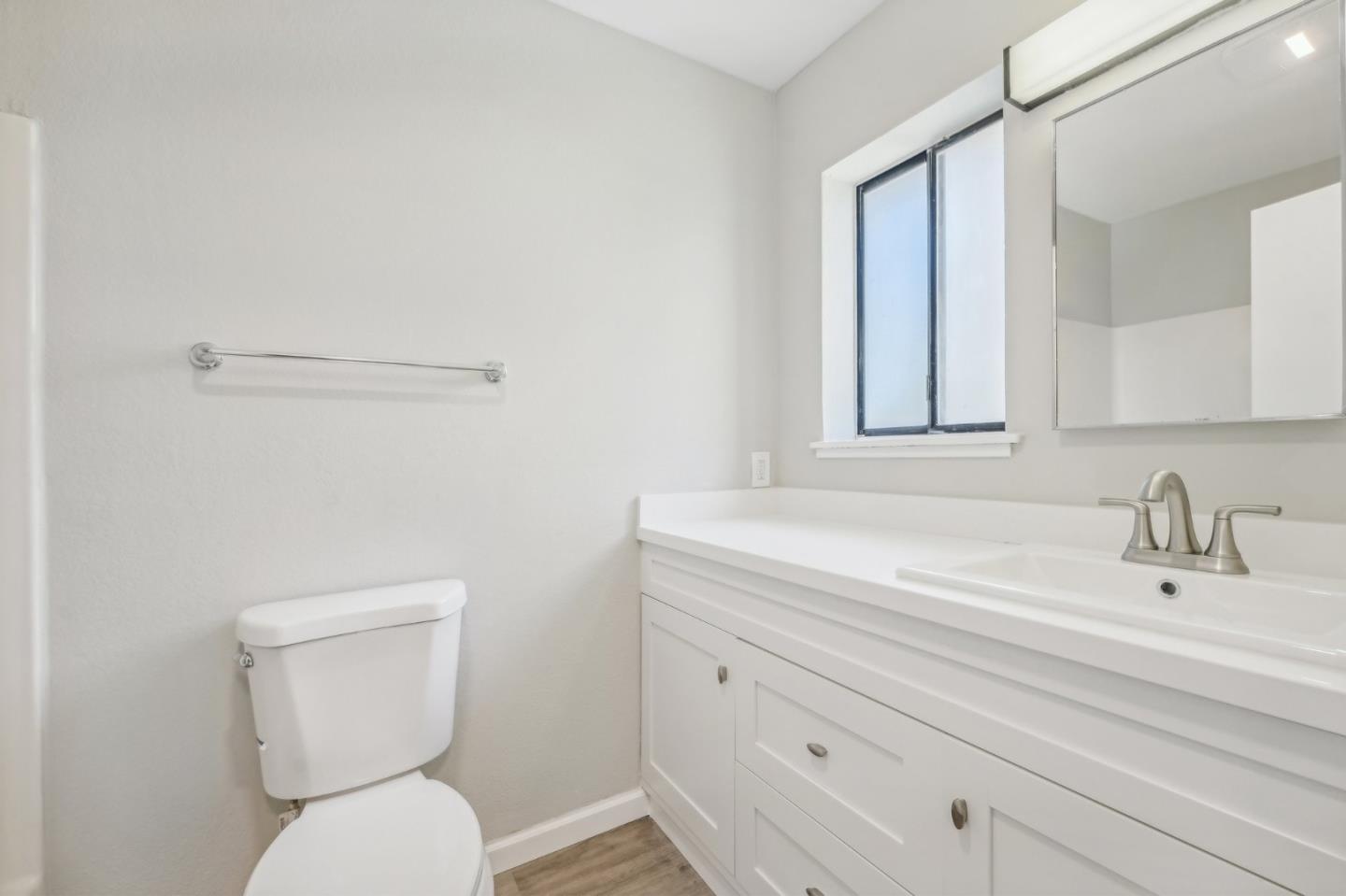 288 Stonegate Circle San Jose, CA 95110 - Photo 14 of 18 a bathroom with a toilet sink and mirror