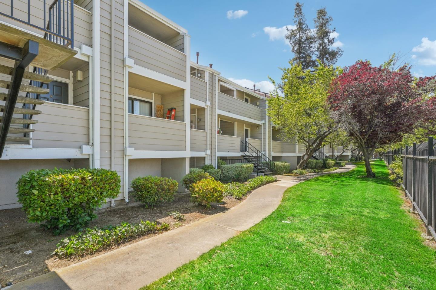 288 Stonegate Circle San Jose, CA 95110 - Photo 2 of 18 a front view of a house with garden