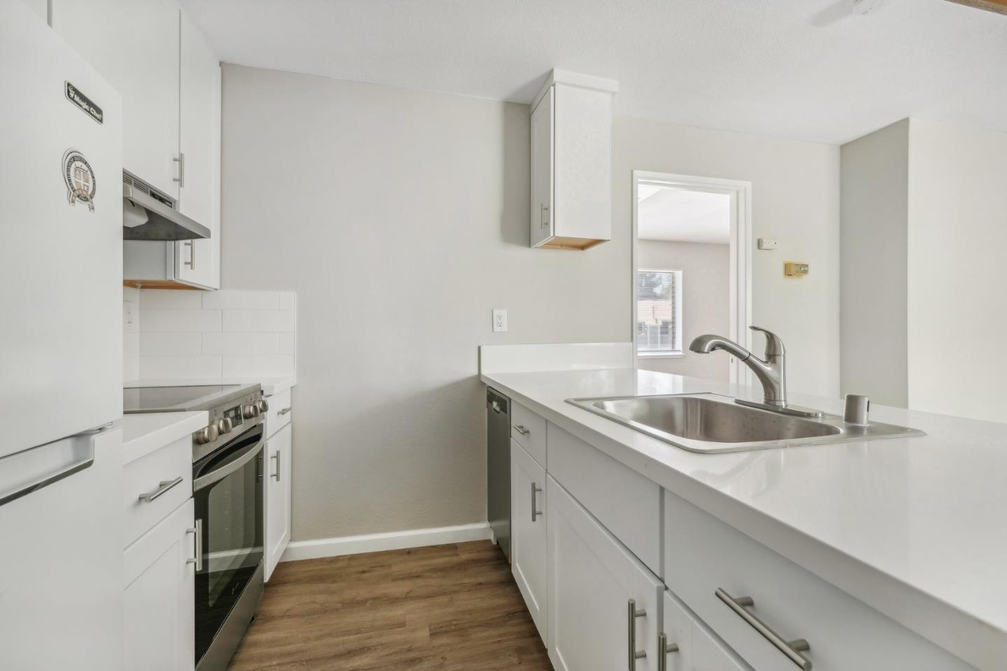 288 Stonegate Circle San Jose, CA 95110 - Photo 4 of 18 a kitchen with a sink and a stove top oven
