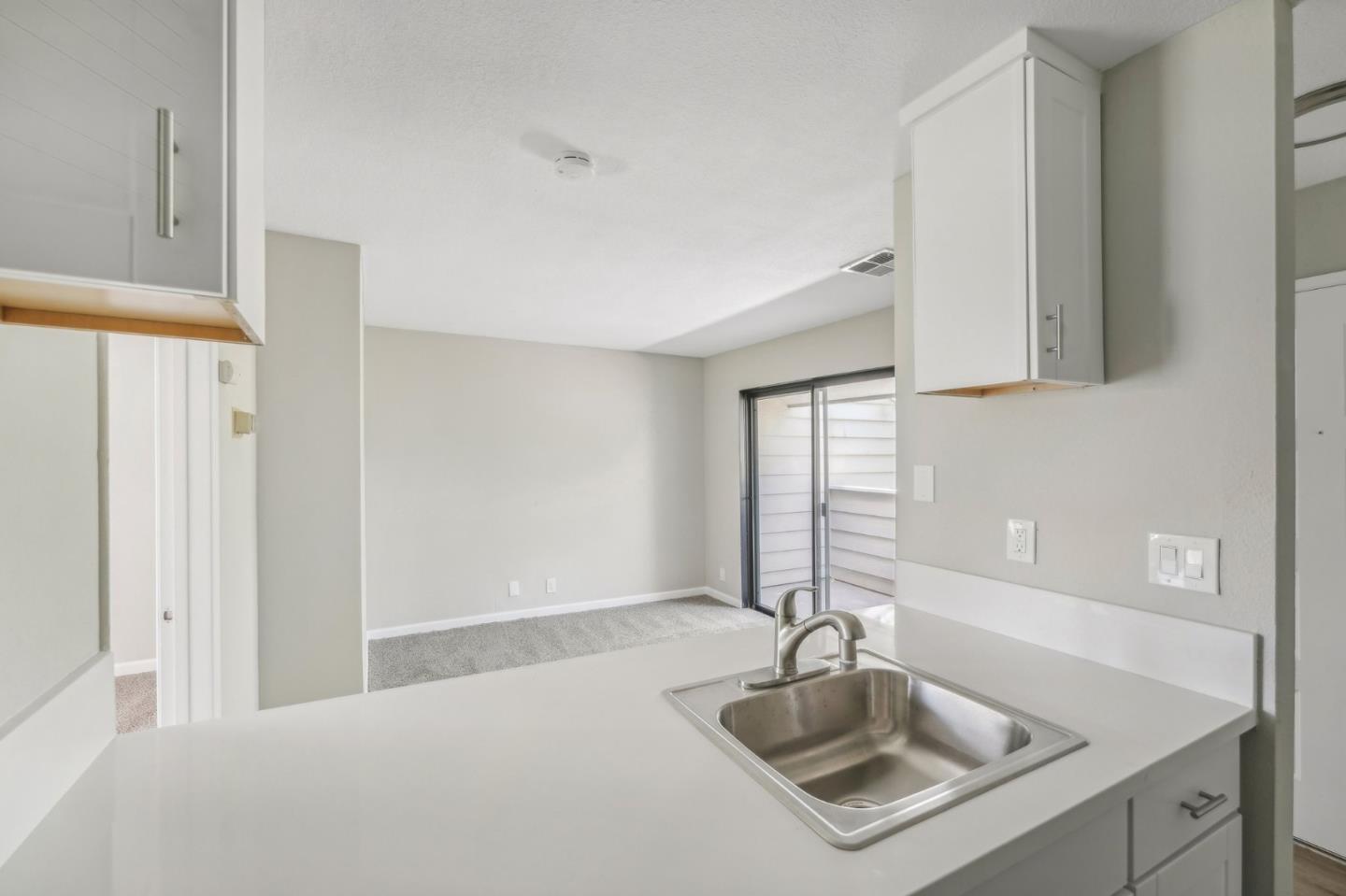288 Stonegate Circle San Jose, CA 95110 - Photo 9 of 18 a kitchen with a sink cabinets and window