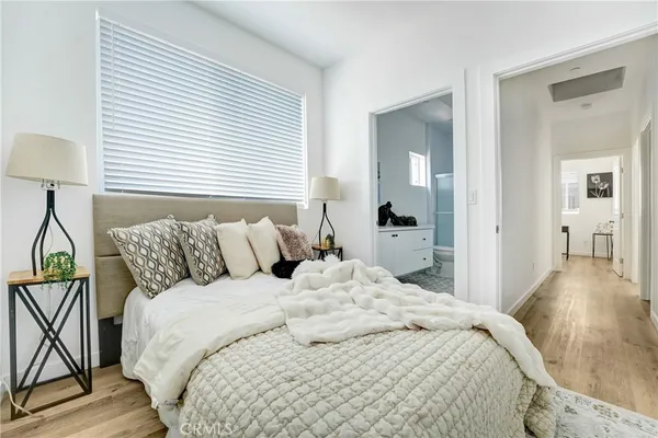 a bed room with a bed and a night stand