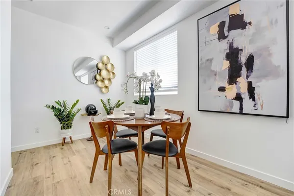 a dining room with furniture and wooden floor