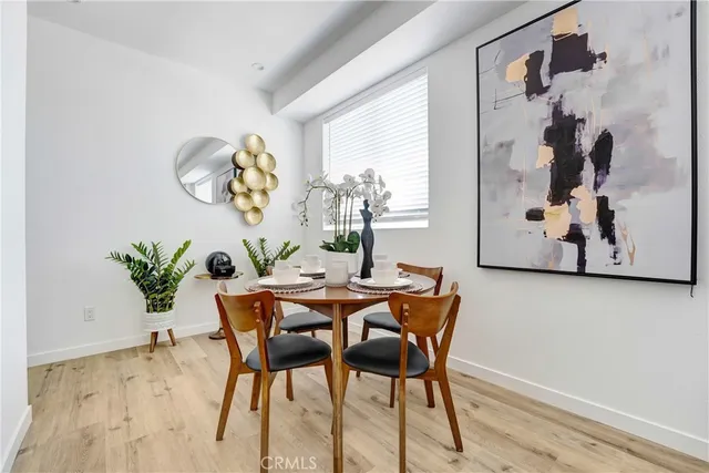 a dining room with furniture and wooden floor