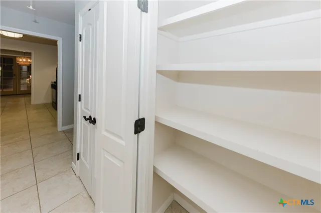 a kitchen with granite countertop a sink a stove top oven and cabinets