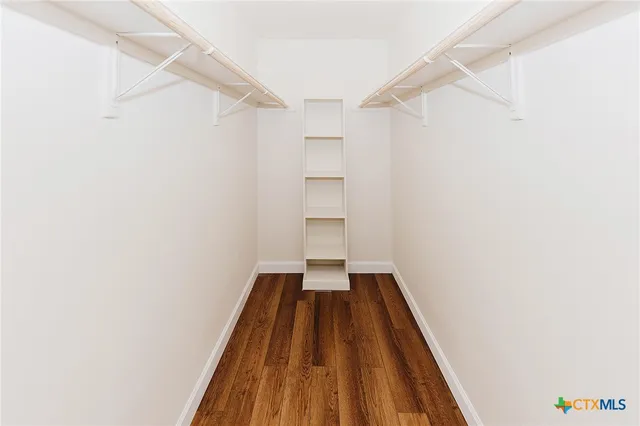 a bathroom with a granite countertop toilet sink and mirror
