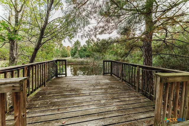 a view of deck with wooden floor and trees