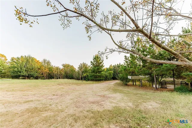 a view of a big yard with a house