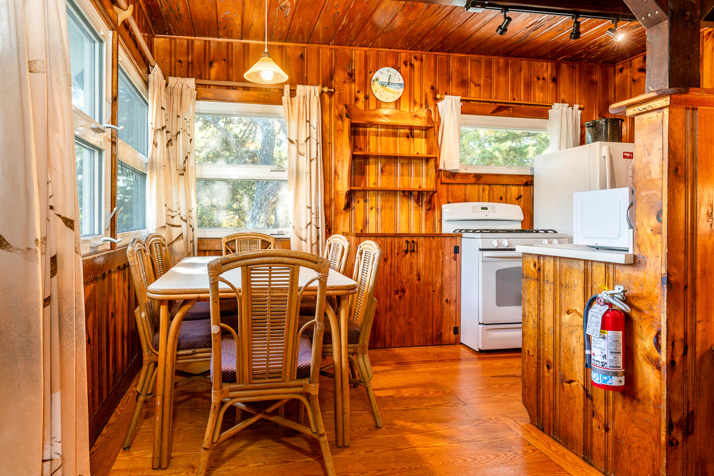 45 Ocean View Drive, Unit 7 Wellfleet, MA 02667 - Photo 4 of 32 a dining room with furniture a flat screen tv and a large window
