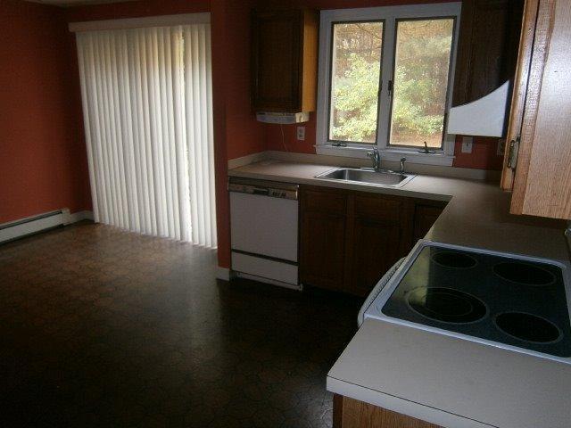 589 Skunknet Road Centerville, MA 02632 - Photo 6 of 15 a kitchen that has a sink and a stove