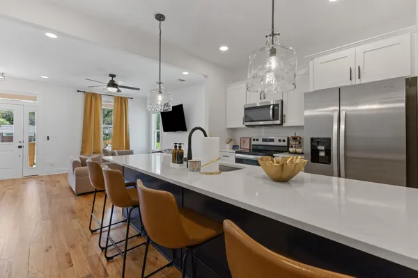 a kitchen with sink refrigerator and microwave