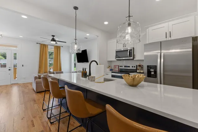 a kitchen with sink refrigerator and microwave