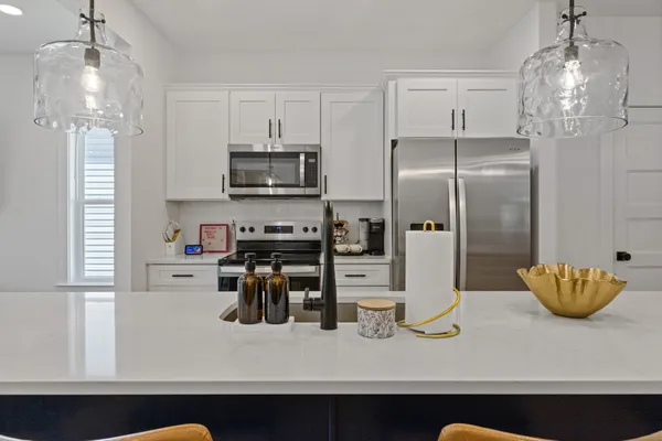 a kitchen with stainless steel appliances a sink and a refrigerator