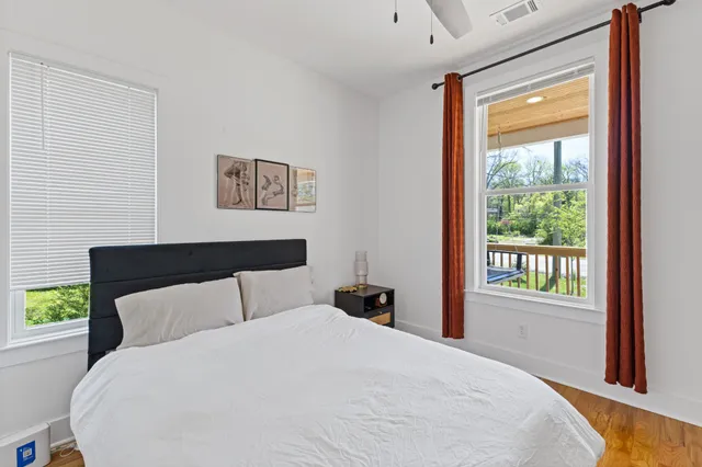 a bedroom with a large bed and a window