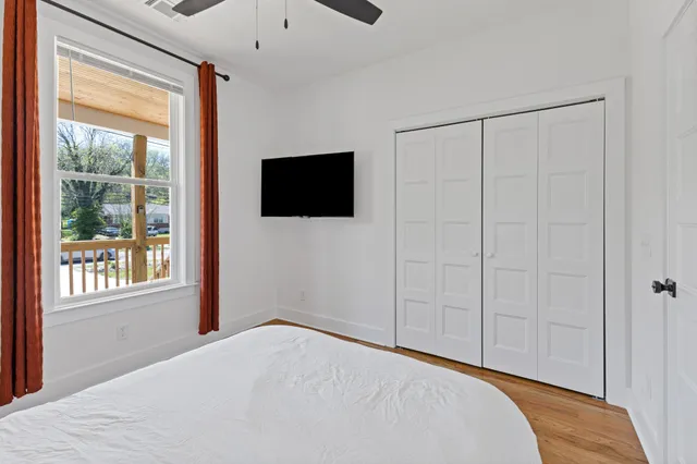 a bedroom with a bed and a flat screen tv