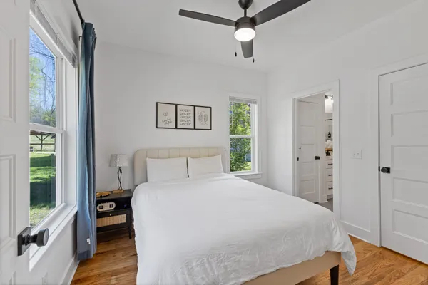 a bedroom with a large bed and a chandelier