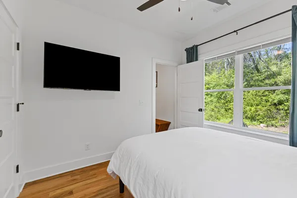 a bedroom with a bed and a flat screen tv