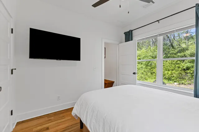 a bedroom with a bed and a flat screen tv