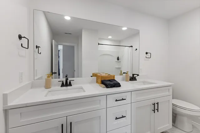 a bathroom with double sink and a mirror