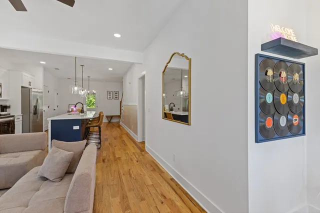 a living room with furniture and a chandelier