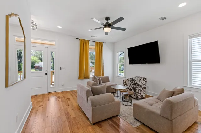 a living room with furniture and a flat screen tv
