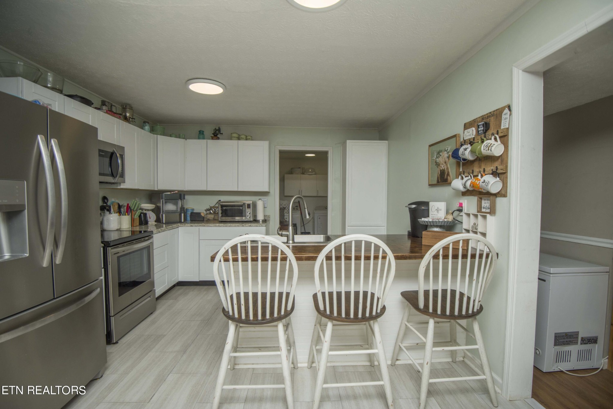 102 Briar Road Oak Ridge, TN 37830 - Photo 11 of 39 a view of a dining room with furniture a kitchen and chandelier