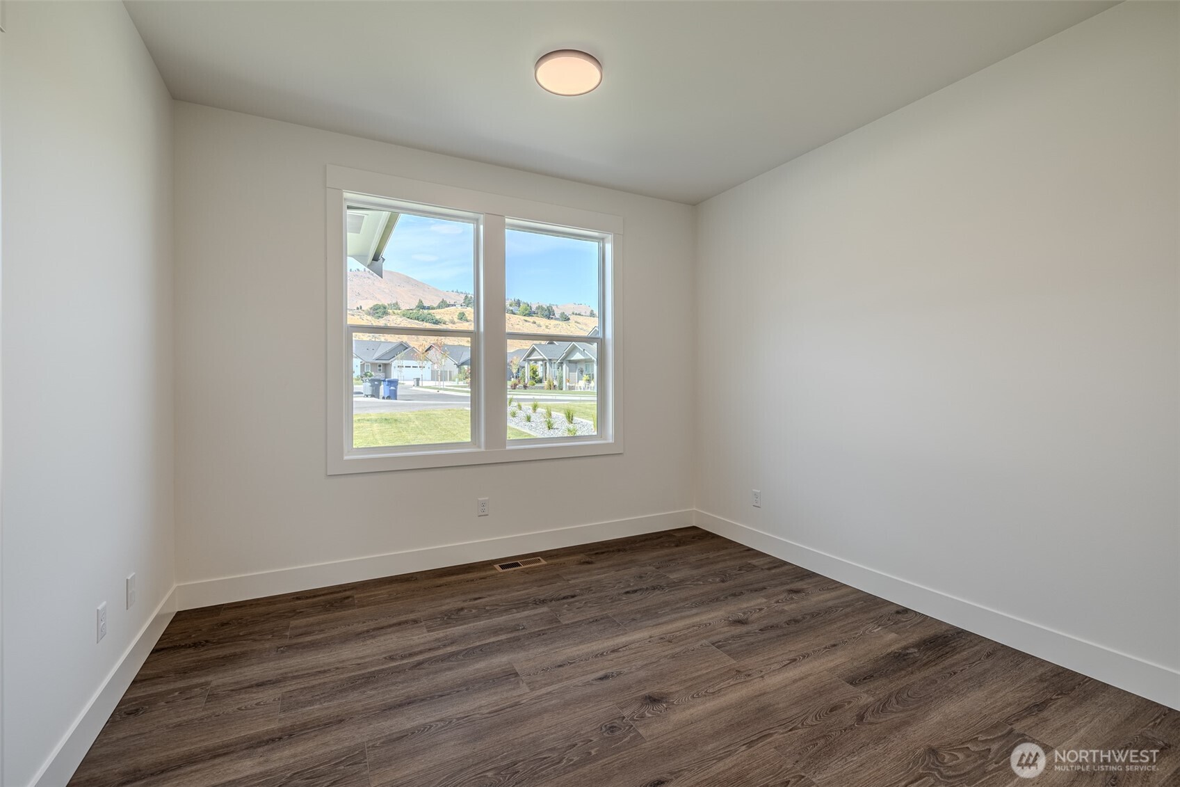 960 Wayne Lane Wenatchee, WA 98801 - Photo 14 of 22 an empty room with wooden floor and windows