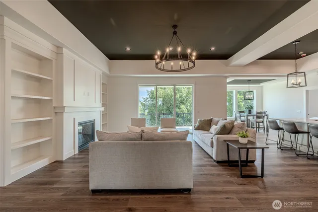 a living room with furniture and a chandelier