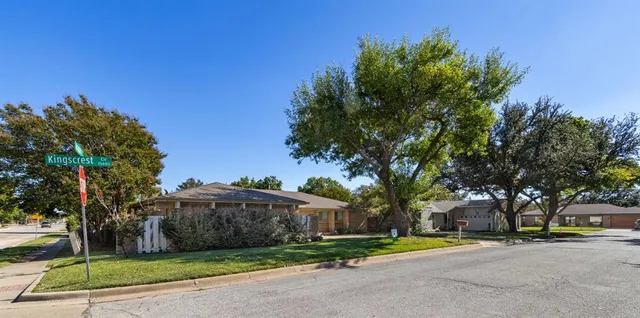 an aerial view of a residential houses with outdoor space and street view