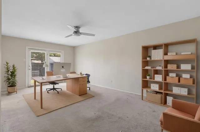 a view of empty room with ceiling fan