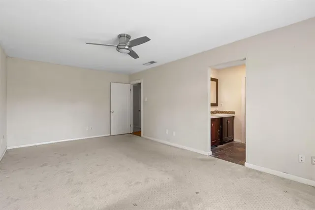 a bathroom with a toilet and shower