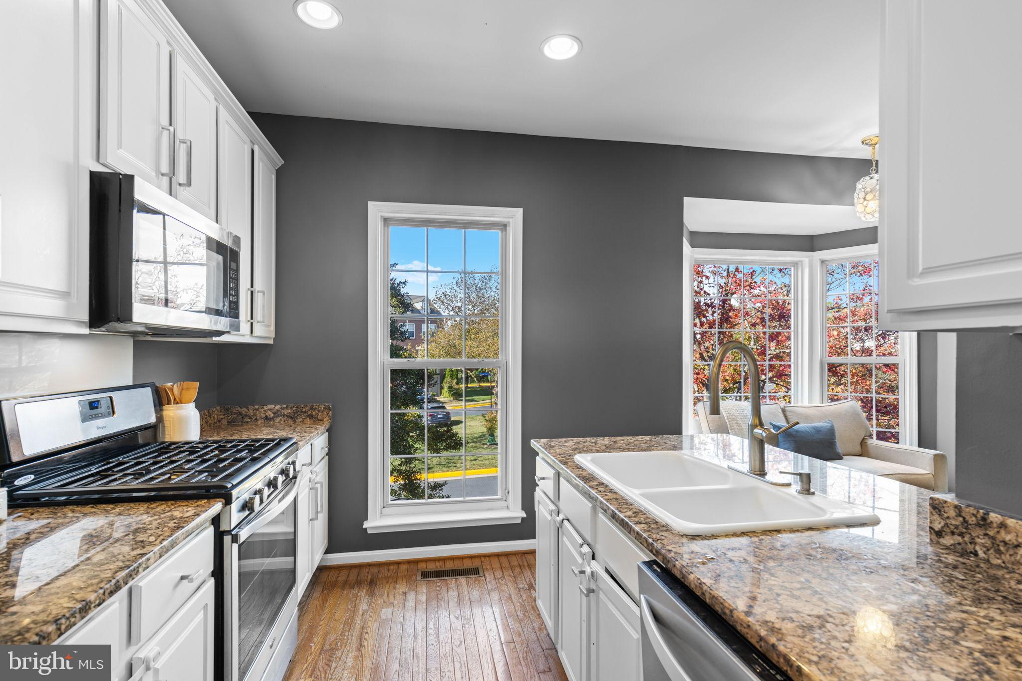 6311 Burgundy Leaf Lane Alexandria, VA 22312 - Photo 10 of 33 a kitchen with a sink stove and cabinets