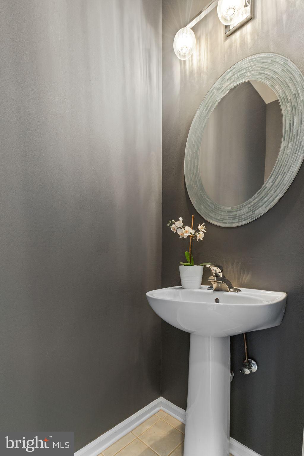 6311 Burgundy Leaf Lane Alexandria, VA 22312 - Photo 12 of 33 a bathroom with a sink and mirror