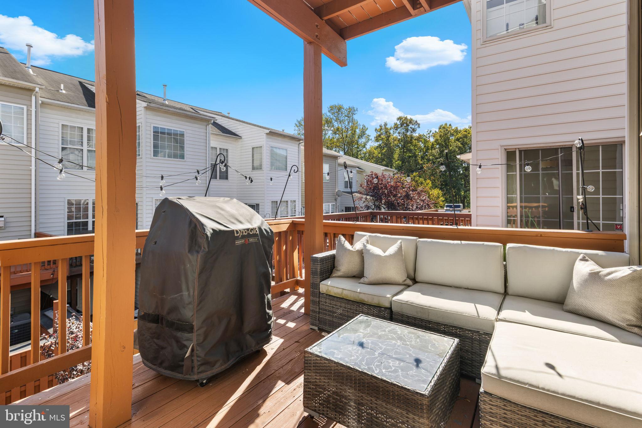 6311 Burgundy Leaf Lane Alexandria, VA 22312 - Photo 13 of 33 a view of a patio with couches and a potted plant on a table