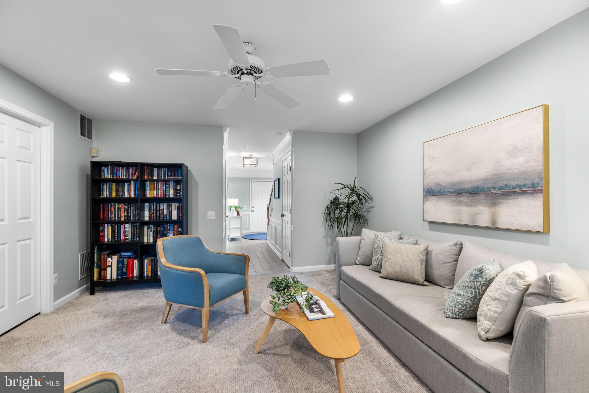 6311 Burgundy Leaf Lane Alexandria, VA 22312 - Photo 18 of 33 a living room with furniture and a book shelf