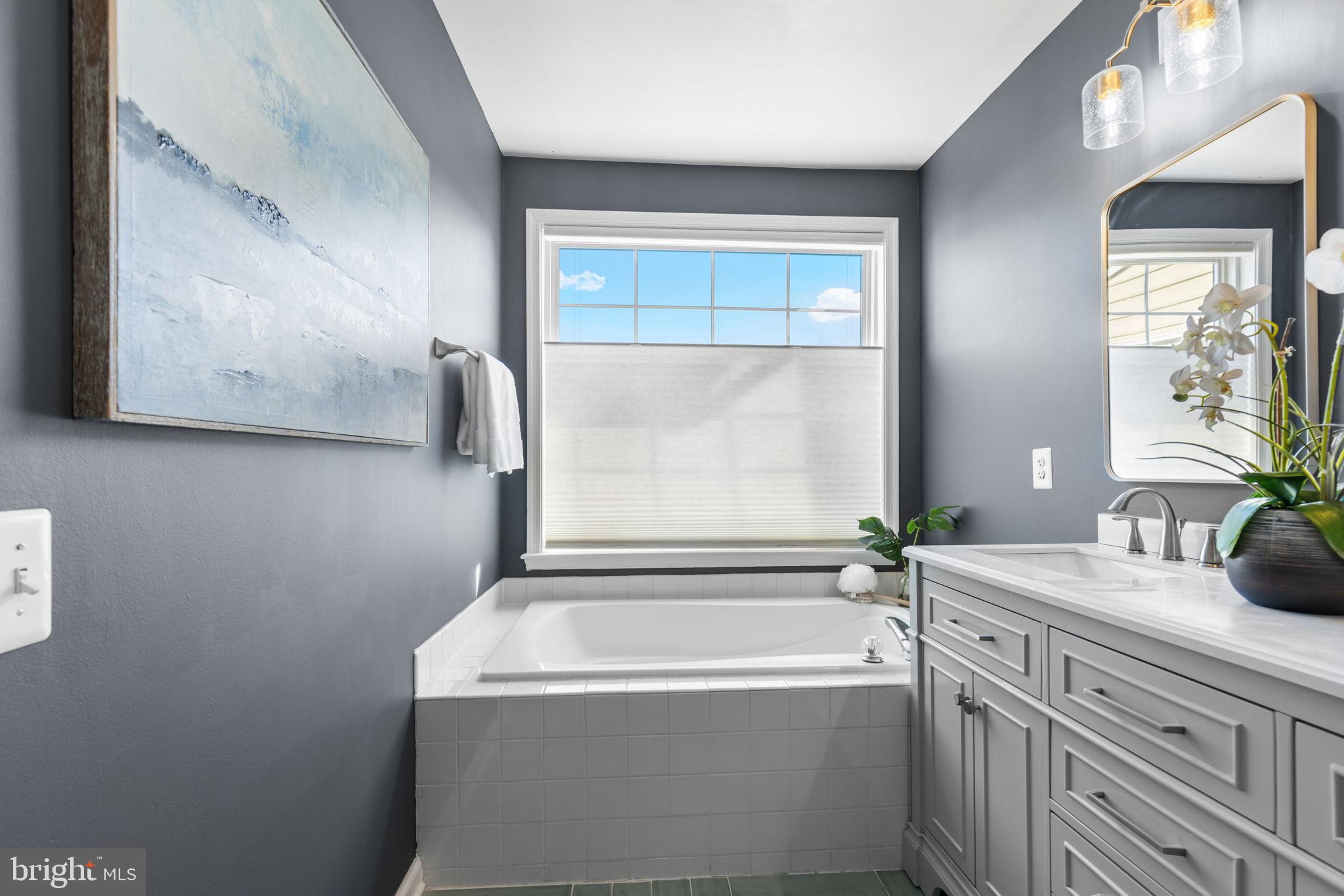 6311 Burgundy Leaf Lane Alexandria, VA 22312 - Photo 22 of 33 a bathroom with a tub sink and mirror